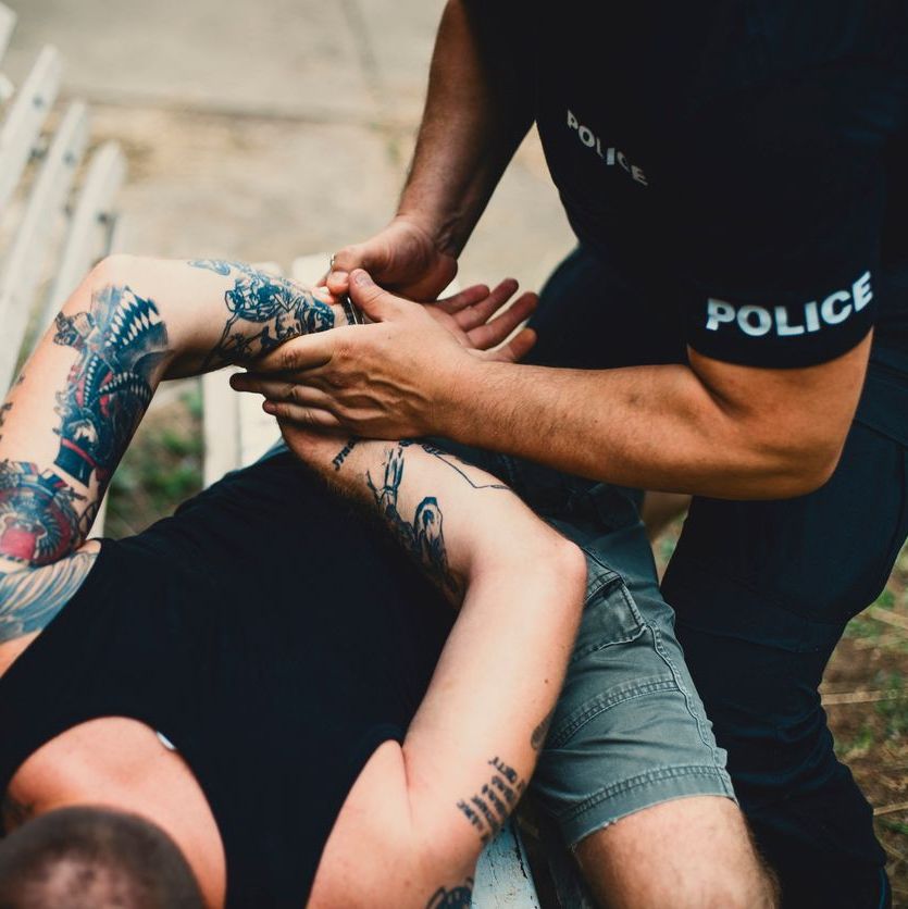 Police putting handcuffs on a man