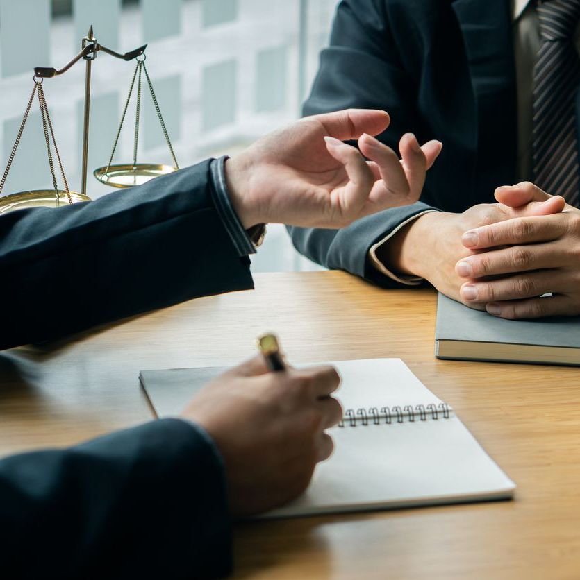 A male lawyer consults a team of legal clients